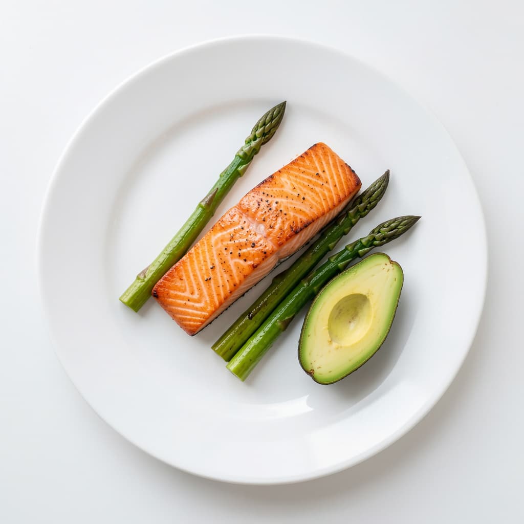 GLP-1 friendly high-protein plate with a seared salmon fillet, roasted asparagus and avocado